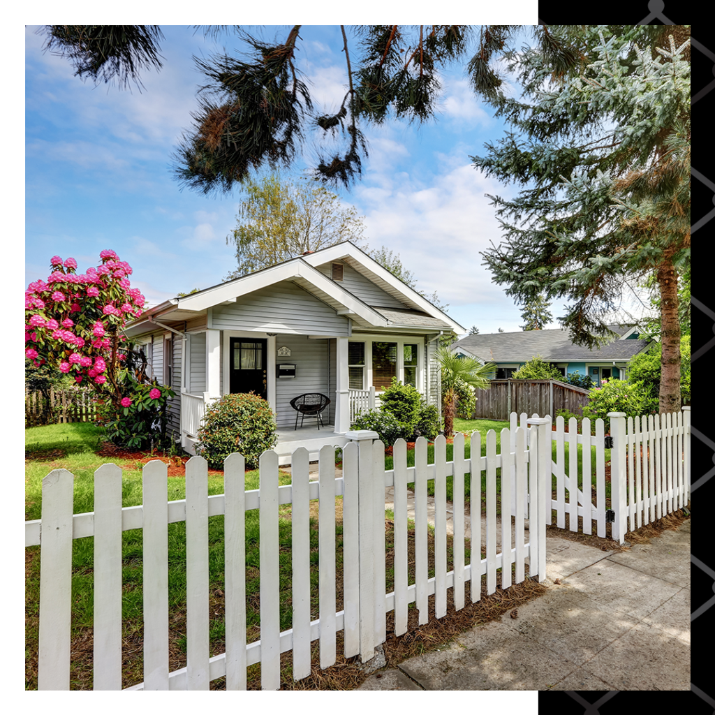 small cottage home with white picket fence around front yard