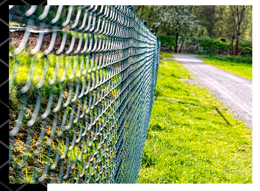 side view of chain link fence next to a grassy area