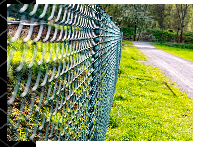 side view of chain link fence next to a grassy area